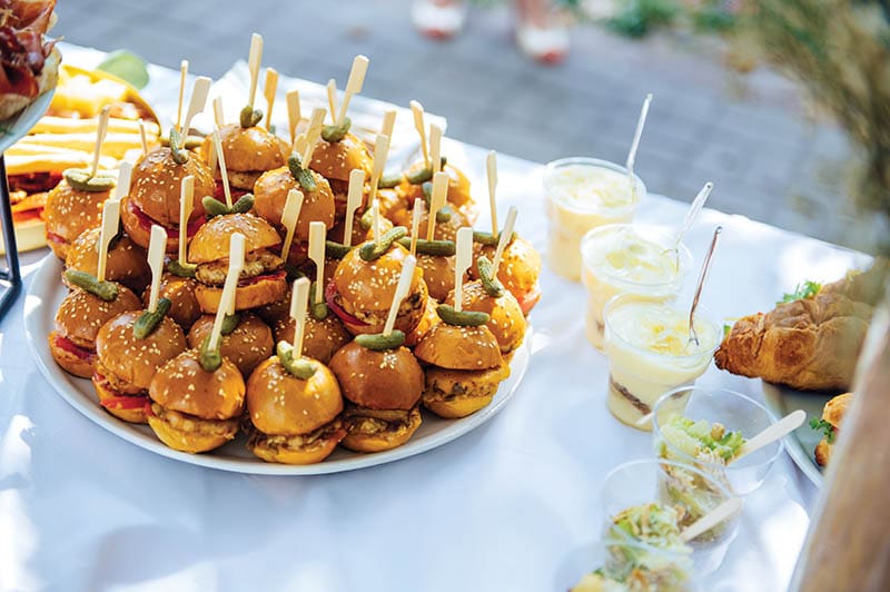 Wedding cake table background. Sweet and delicious restaurant desserts. Tasty food on buffet party. Banquet snacks texture. Catering table background.