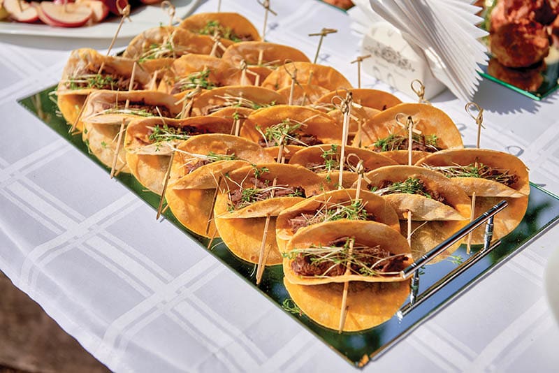 Buffet table with snacks, canape, sandwiches and appetizers at luxury wedding reception outdoors, copy space. Serving food. Catering banquet table. Homemade Tacos