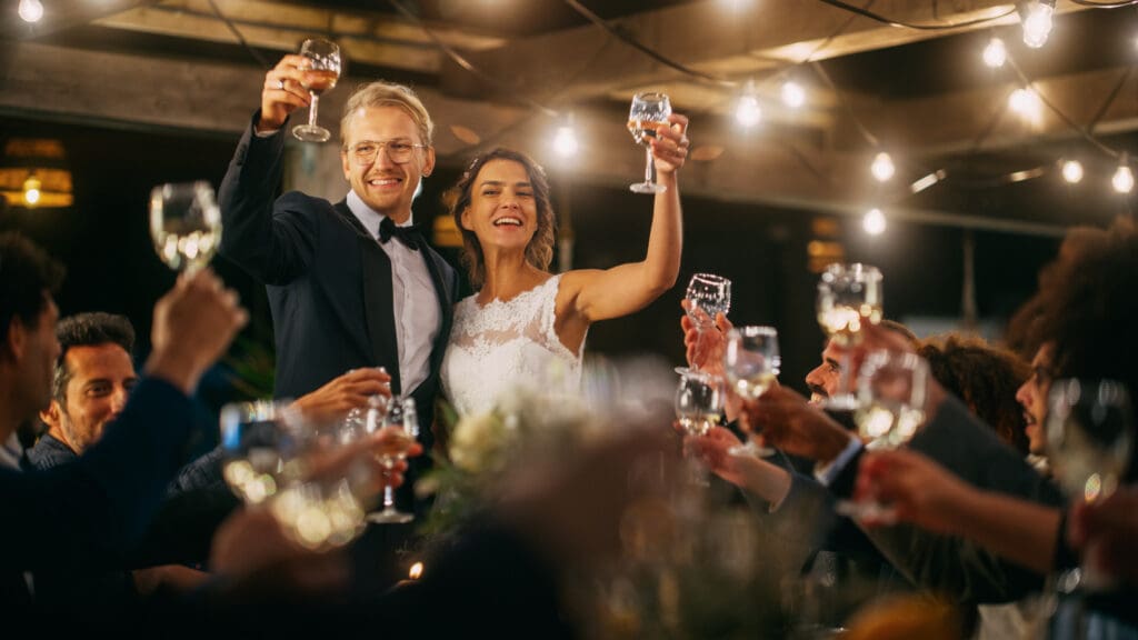 Wedding couple toasting GettyImages 1388561747